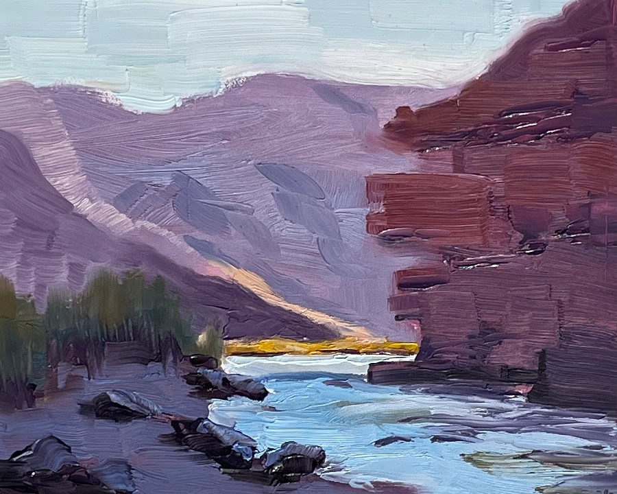 Oil painting of river and one bank in the shade of a cliff. The sun falls on the part of the river beyond the cliff and a sliver of the mountain in the distance.